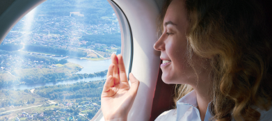 Traveler looking through an airplane window